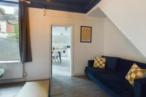 A bright and inviting living room featuring a c...