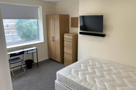 A spacious and well-lit double bedroom featurin...