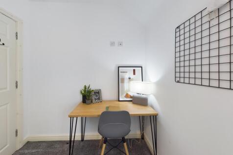 A bright and tidy communal workspace featuring ...