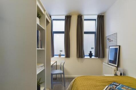 A bright and inviting double bedroom featuring ...