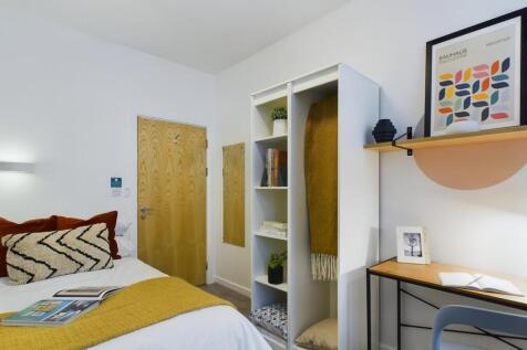 A bright and inviting double bedroom with styli...
