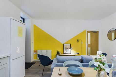 A bright and modern living room featuring a sty...