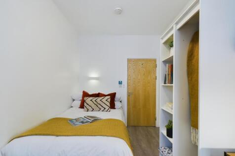 A bright and inviting double bedroom featuring ...
