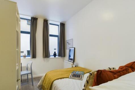 A bright and cozy double bedroom featuring ampl...