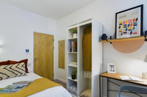 A bright and inviting double bedroom with a coz...