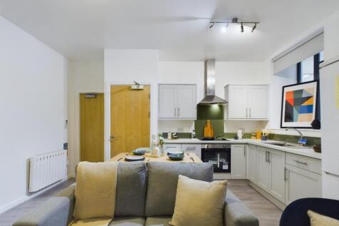 A modern and inviting kitchenette with ample na...