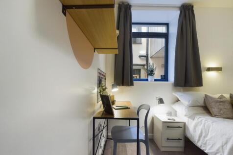 A bright and inviting double bedroom featuring ...