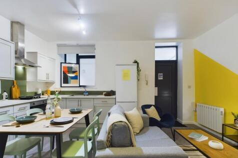 A bright and modern kitchenette with a spacious...