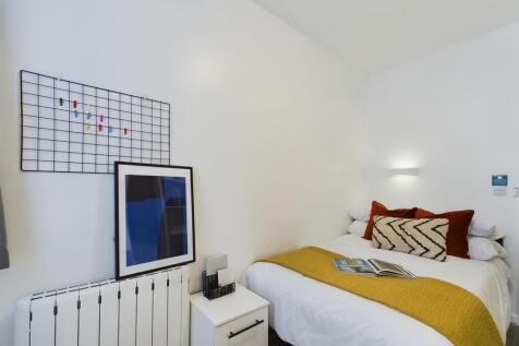 A bright and inviting double bedroom featuring ...