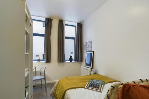 A bright and inviting double bedroom with moder...