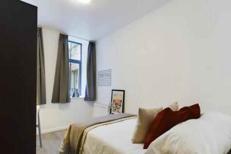 A bright and inviting double bedroom featuring ...
