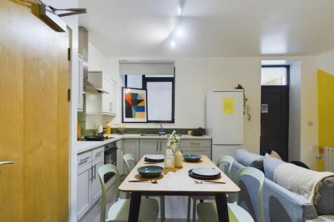 A bright and modern kitchen area with a welcomi...