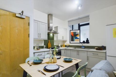 A modern and inviting kitchenette with ample sp...