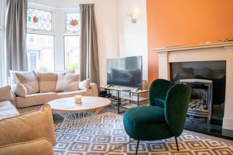 A stylish and spacious modern living room featu...