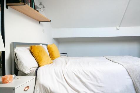 A bright and inviting double bedroom featuring ...