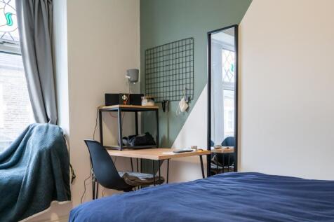 A bright and inviting double bedroom featuring ...