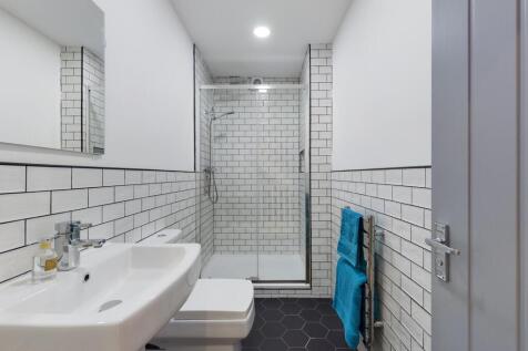 Bright and modern bathroom featuring a spacious...