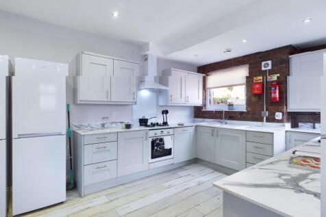 Bright and modern kitchen featuring ample stora...
