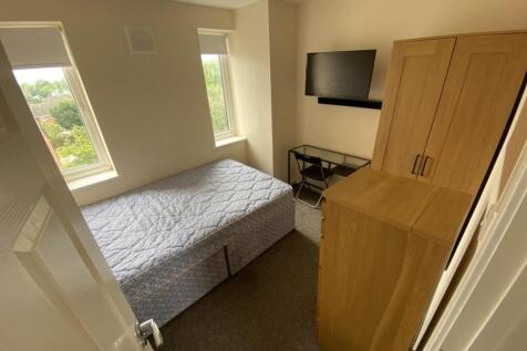 A bright and tidy double bedroom featuring larg...