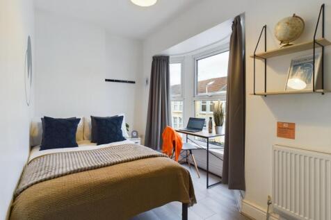 A bright and inviting double bedroom with ample...