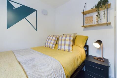 A bright and inviting double bedroom featuring ...