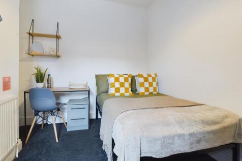 A bright and inviting double bedroom featuring ...