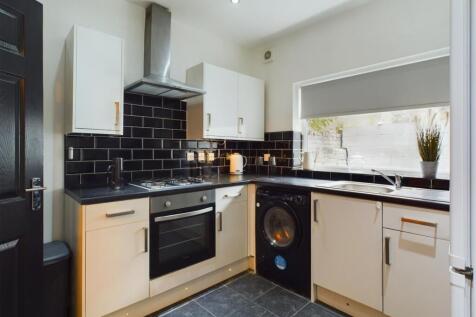 A modern and well-equipped kitchenette featurin...