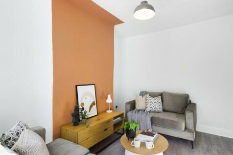 A bright and inviting living room with modern d...