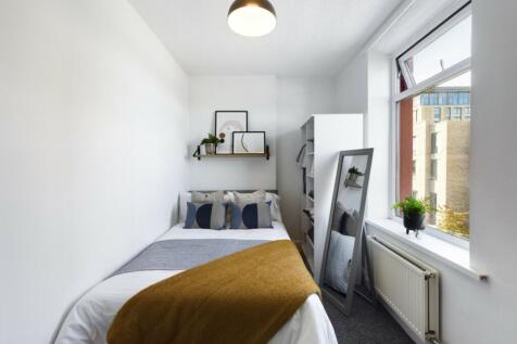 A bright and inviting double bedroom featuring ...