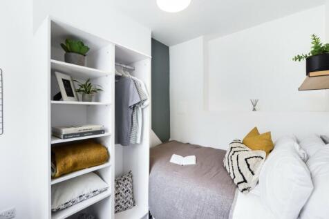 A bright and tidy double bedroom featuring styl...