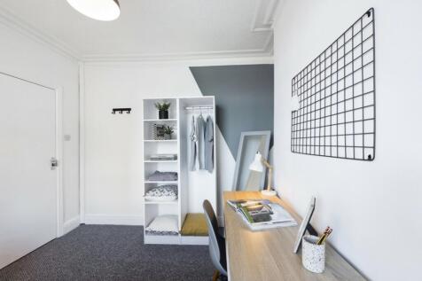 A bright and stylish double bedroom featuring a...