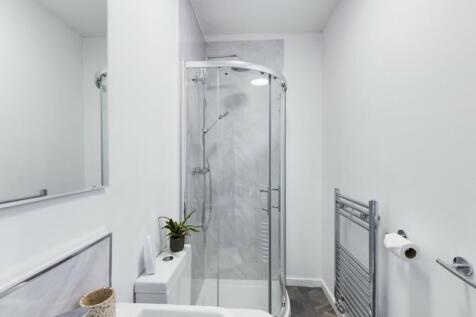 A modern and pristine bathroom featuring a styl...