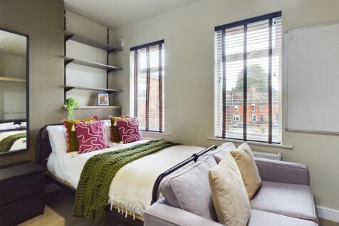 A bright and inviting double bedroom featuring ...