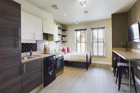 A modern and stylish kitchenette with ample spa...