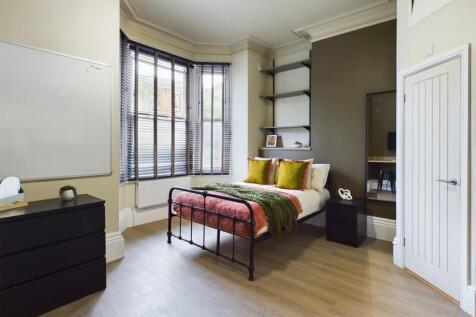 A bright and inviting double bedroom, featuring...