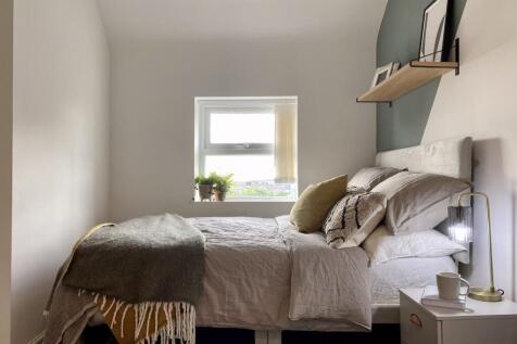 A bright and inviting double bedroom featuring ...