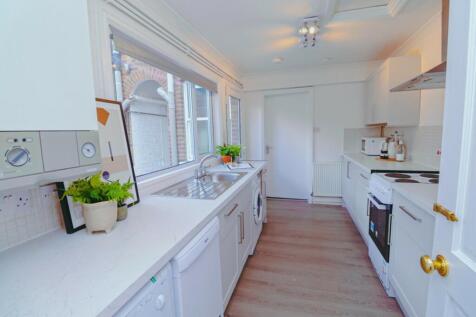 A bright and modern kitchen with ample natural ...