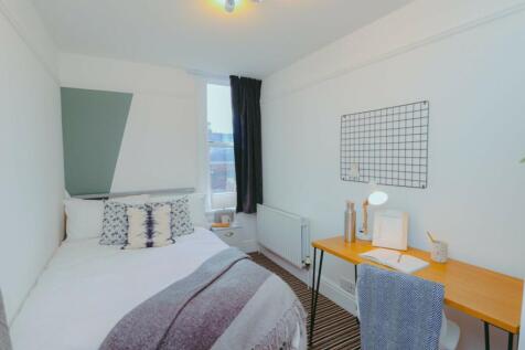 A bright and inviting double bedroom featuring ...