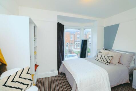 A bright and inviting double bedroom featuring ...