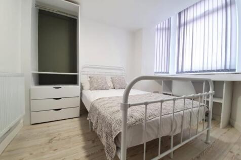 A bright and tidy double bedroom featuring ampl...