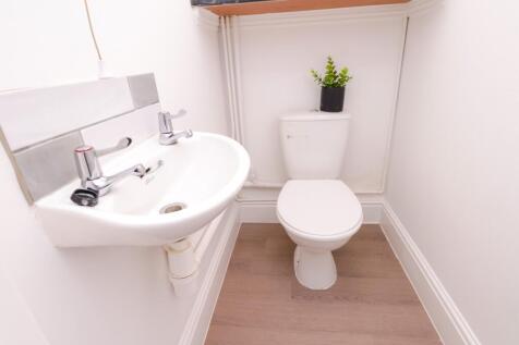 A tidy and well-maintained single toilet with m...