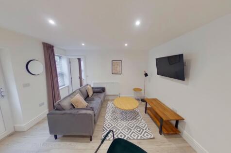 A spacious and modern living room featuring sty...