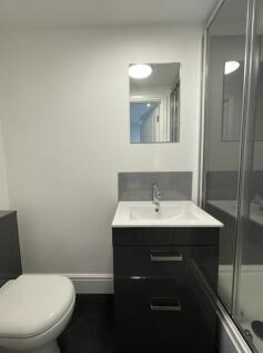 A modern and clean bathroom featuring sleek fix...