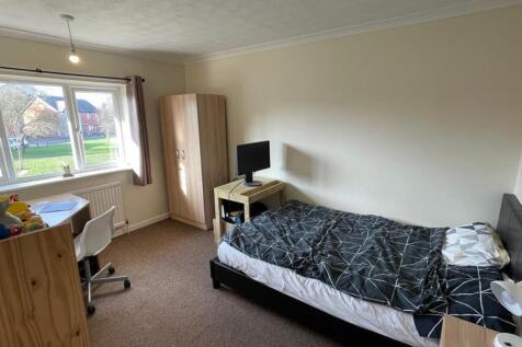 A spacious and bright double bedroom featuring ...