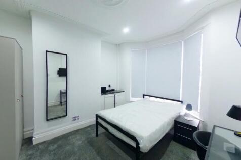 A bright and spacious double bedroom with moder...