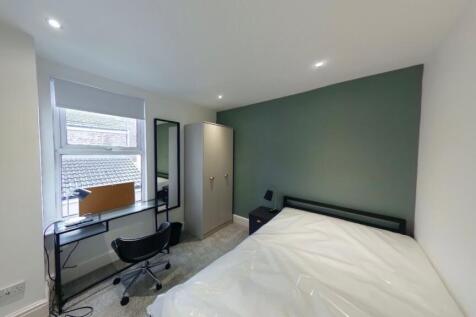A bright and modern double bedroom featuring a ...