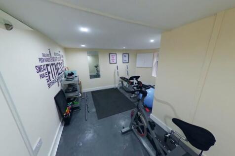 A bright and clean gym space equipped with exer...