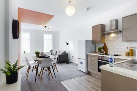 A modern and spacious kitchenette with ample na...