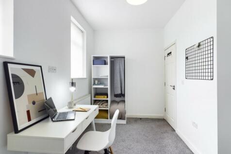 A tidy and well-lit study area featuring a desk...