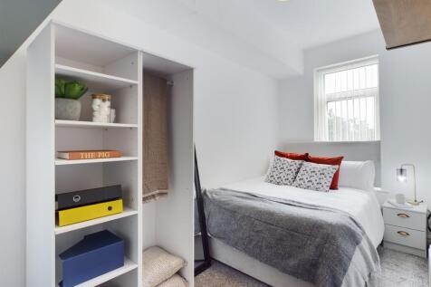 A stylish and well-organized double bedroom, fe...